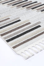 Le Canvas Ione — Stone and grey rug, corner and tassel detail