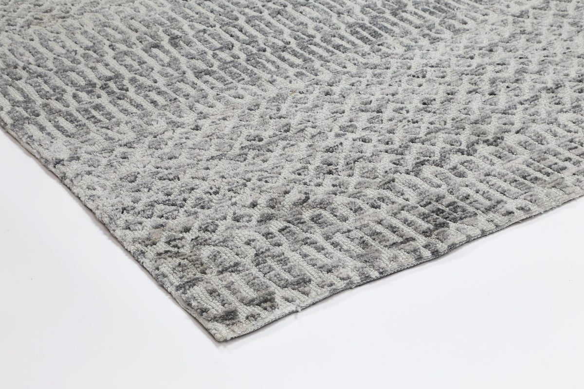 Le Canvas Kira — Grey tribal-geometric rug, showing rug back weave and edge finish