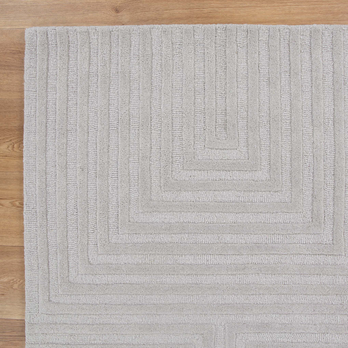 Le Canvas Wren — Light grey rug, corner detail on timber floor