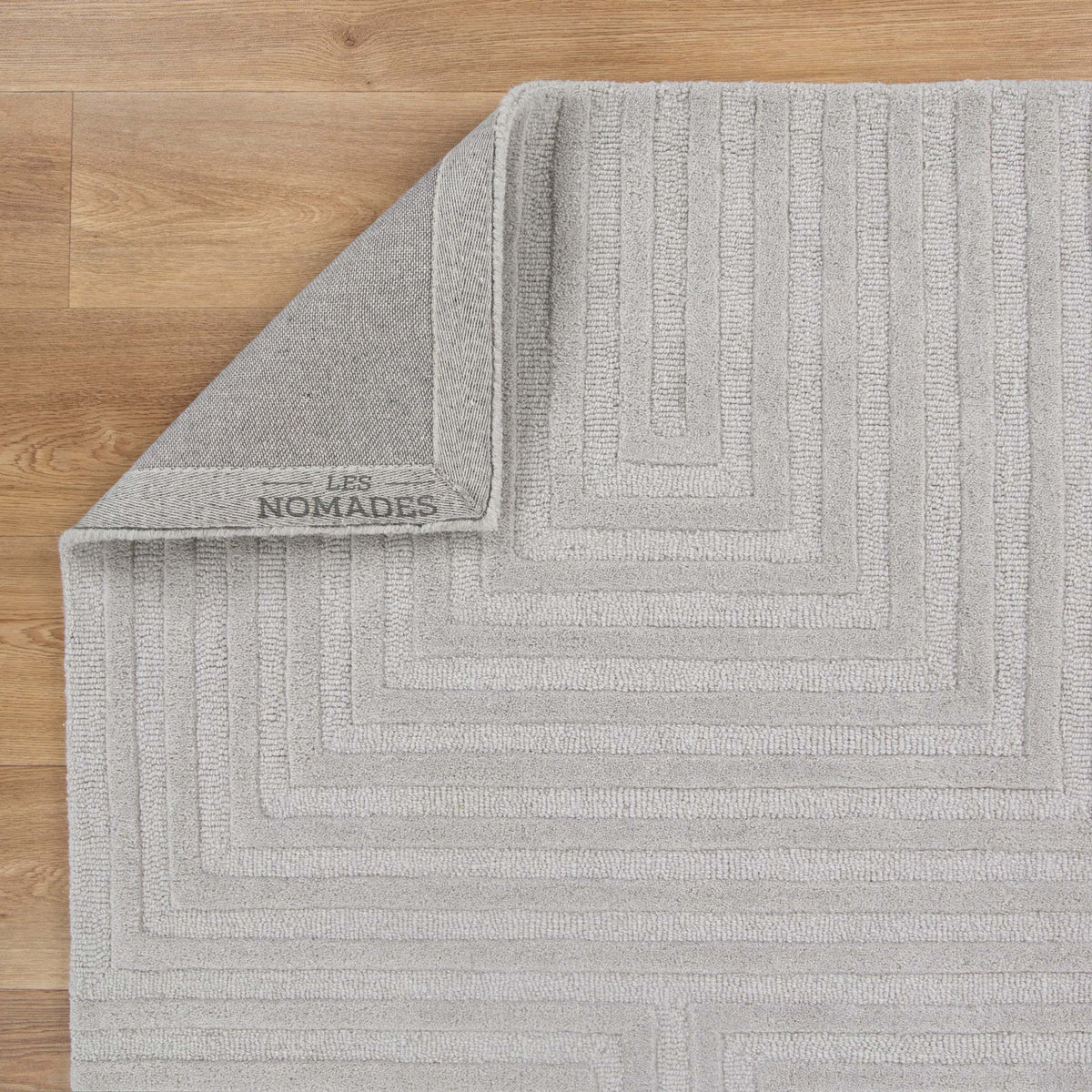 Le Canvas Wren — Light grey rug, showing rug back weave and edge finish