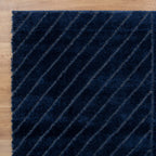 Le Canvas Cove — Navy rug, top-down view