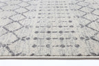 Le Canvas Elowen — Ivory and grey geometric rug, corner and bound-edge detail