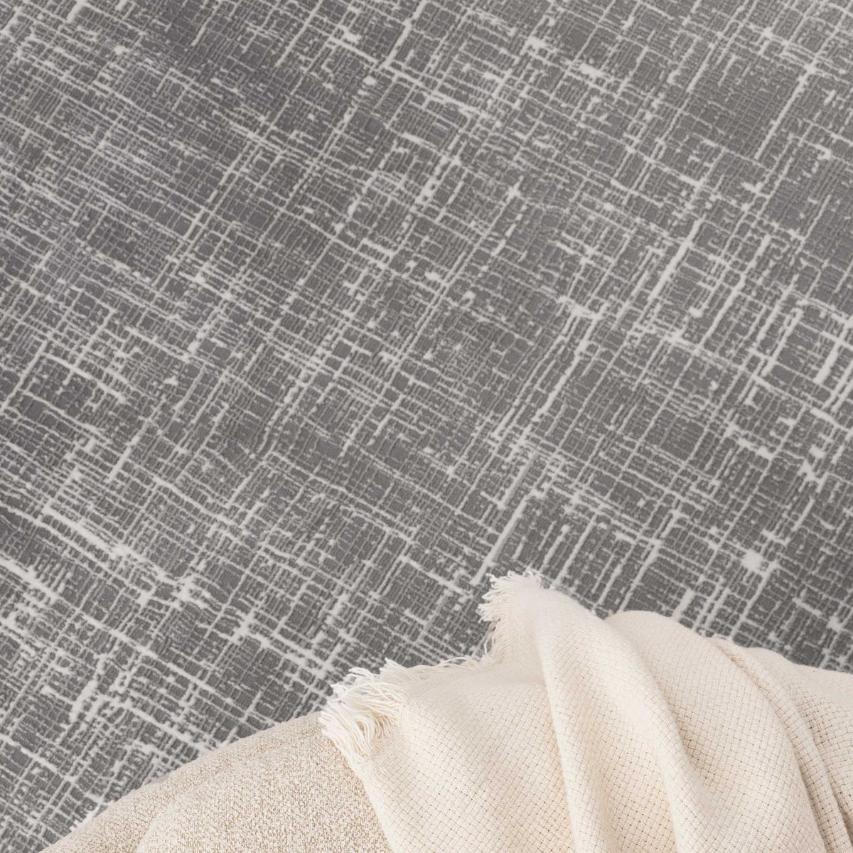 Le Canvas Marlow — Grey rug, texture close-up with a soft throw
