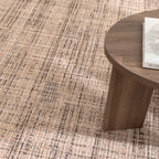 Le Canvas Elara — Beige Grey rug, close-up in a styled interior with walnut coffee table