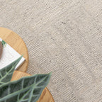 Lumen Silver wool rug styled beside a timber table