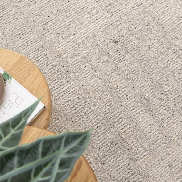 Lumen Silver wool rug styled beside a timber table